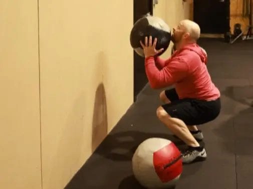 Athlete training in a dark gym environment at Formidable Strength and Conditioning
