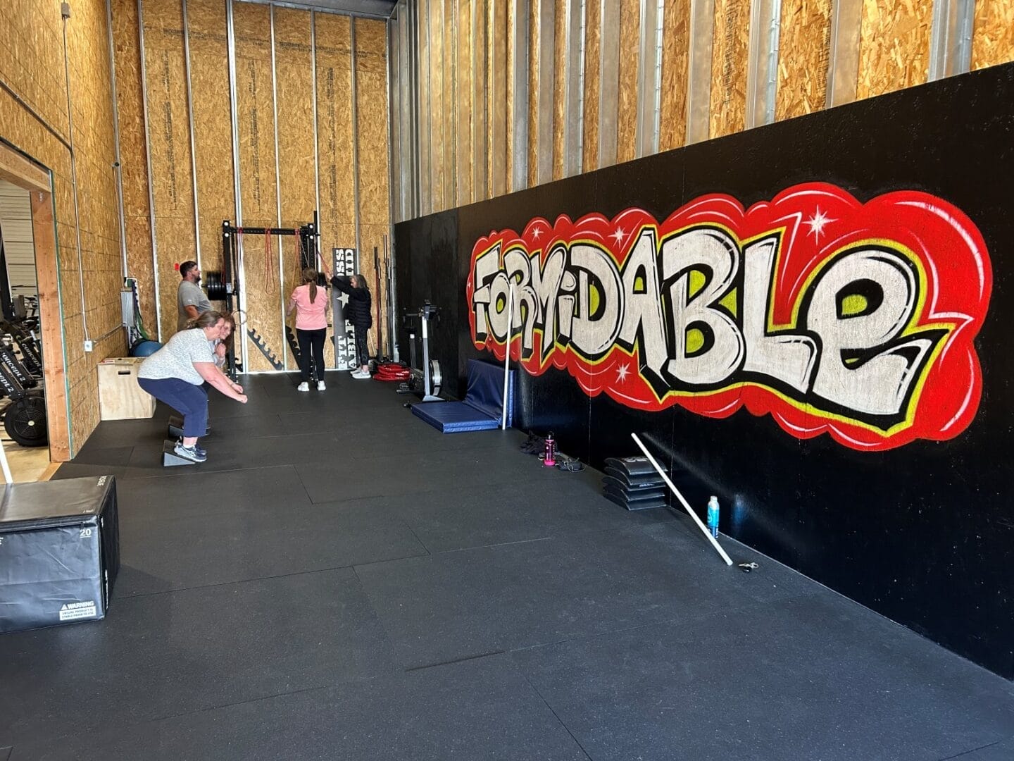 Adult choosing between small group training and personal training at a coaching-first gym